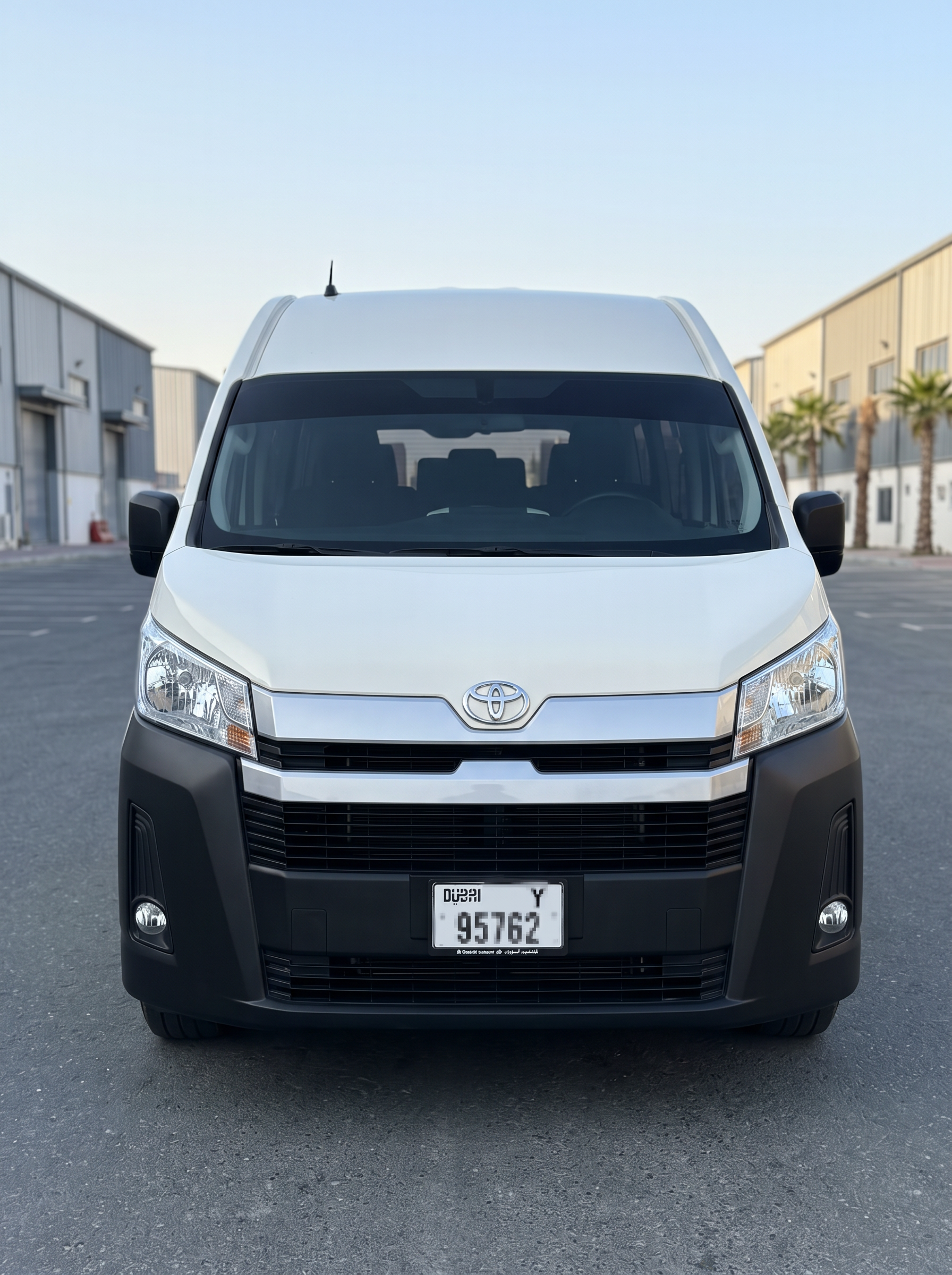Close-up front grille and headlamps of Toyota Hiace 14-seater rental van in the UAE