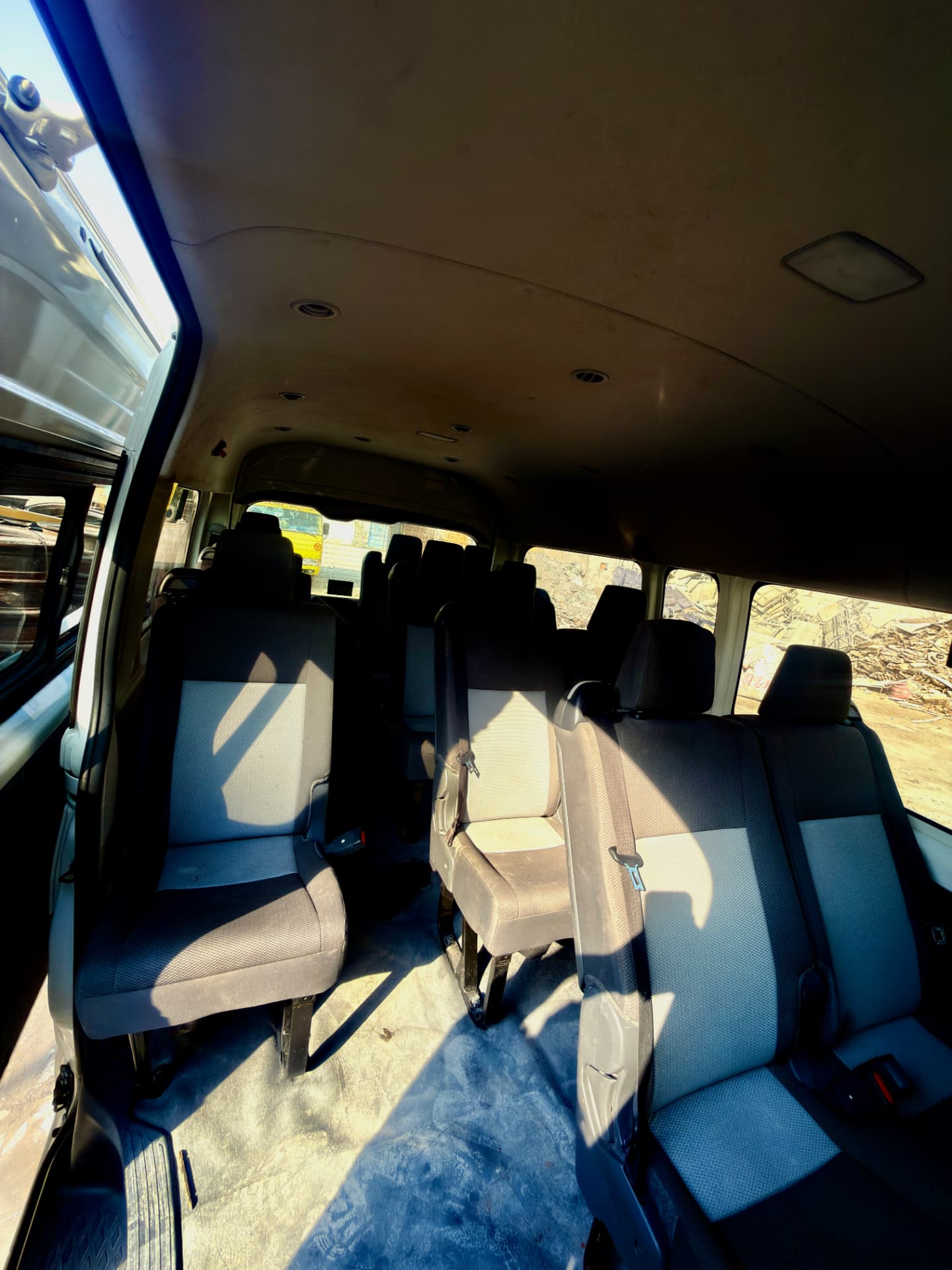 Interior of 14-seater Toyota Hiace with high-back fabric seats and three-point seat belts